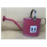 Watering can with international harvester sticker
