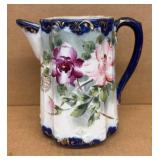 Antique hand-painted porcelain pitcher with
