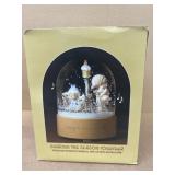 Precious moment, snow globe sharing the season