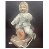 Boy sitting on log handmade figure