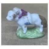 Porcelain girl, riding dog figure