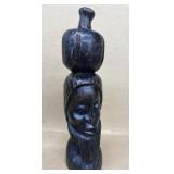 Wooden old man's sculpture carrying pot on head