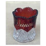 Souvenir cranberry colored plastic glass Mount