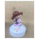 Musical little girl holding teddy bear
