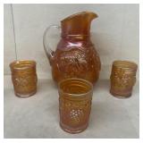 Carnival glass water, pitcher, and glasses
