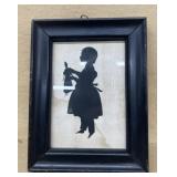 Silhouette girl holding doll