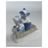 Porcelain kid skiing figurine