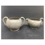 Early pewter creamer and sugar
