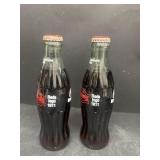 Two Cincinnati Reds logo Coke bottles