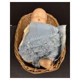 Antique doll in basket