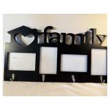 Family picture frame with coat hooks