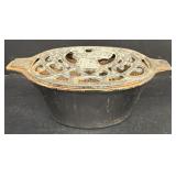 Cast-iron roaster with chicken on top