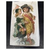 Antique paper cut out of boy and girl holding