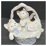 Porcelain cats and a basket