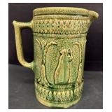 Green Yellow Ware Stoneware Pitcher with Figure