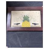 Decorative birds sitting on fence with pineapple