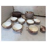 Brown white dishes, some have chips