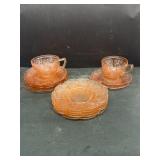 Pink glass plates with two tea cups