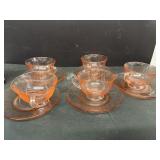 Pink depression, glass, cups, and saucers
