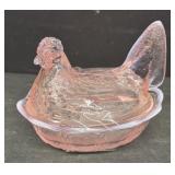 Pink Fenton hen on a nest