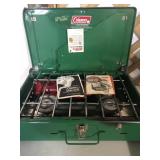 Coleman camp stove with paperwork