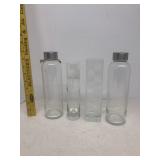 Two glass bottles two glass bud vases