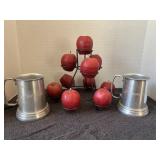 Vintage pewter mugs and apple candles in holder