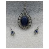 necklace with a large dark blue stone pendant and