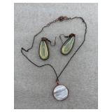 necklace with a round pendant and matching