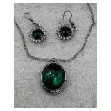 silver-tone chain necklace with a large green gem