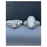 large oval white moonstone on one and a round