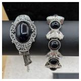 Silver tone bracelets with black cabachon accents