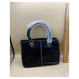 black handbag featuring gold-toned hardware and a