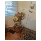 Tiered Plant Stand with Floral Arrangements and Decorative Bugs