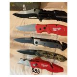 Display of 5 knives that are folders all new