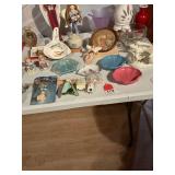 Right half of table has several unique items, collection of decorative night lights, several treasures