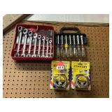 1 set of new Gear wrench combo wrenches, 1 used set of Craftsman nut drivers, 2 new Stanley 25 ft. tapes