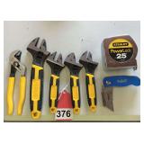 1 Adjustable pliers, 4 piece set of Stanley adjustable wrenches, 25 ft. tape and 1 Larry flashlight