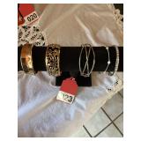 2 gold bracelets and 3 silver bracelets.