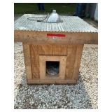 Real Nice large dog house, just enlarge entrance and plug in the heat lamp and your pup will stay cozy.