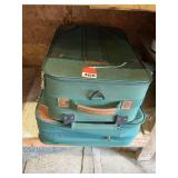 2 matching nice suit cases, 1 for check in and 1 for carry on, both have handles and wheels.