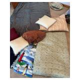 Assorted blankets pillows, and one weighted blanket