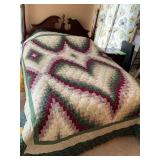 Machine quilted, dark floral bargello heart quilt with prairie points