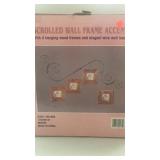 Wire scroll hanger for 4 framed pictures.