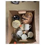Box of glassware and a carved coconut figure