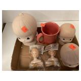 Five doll heads and a ceramic cup. Three of the