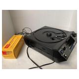 Kodak carousel projector and seven slide trays.