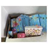 Box of party supplies including candles balloons