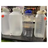 4 plastic liquid storage containers.