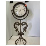 Clock on metal  stand. 22in high. Works!